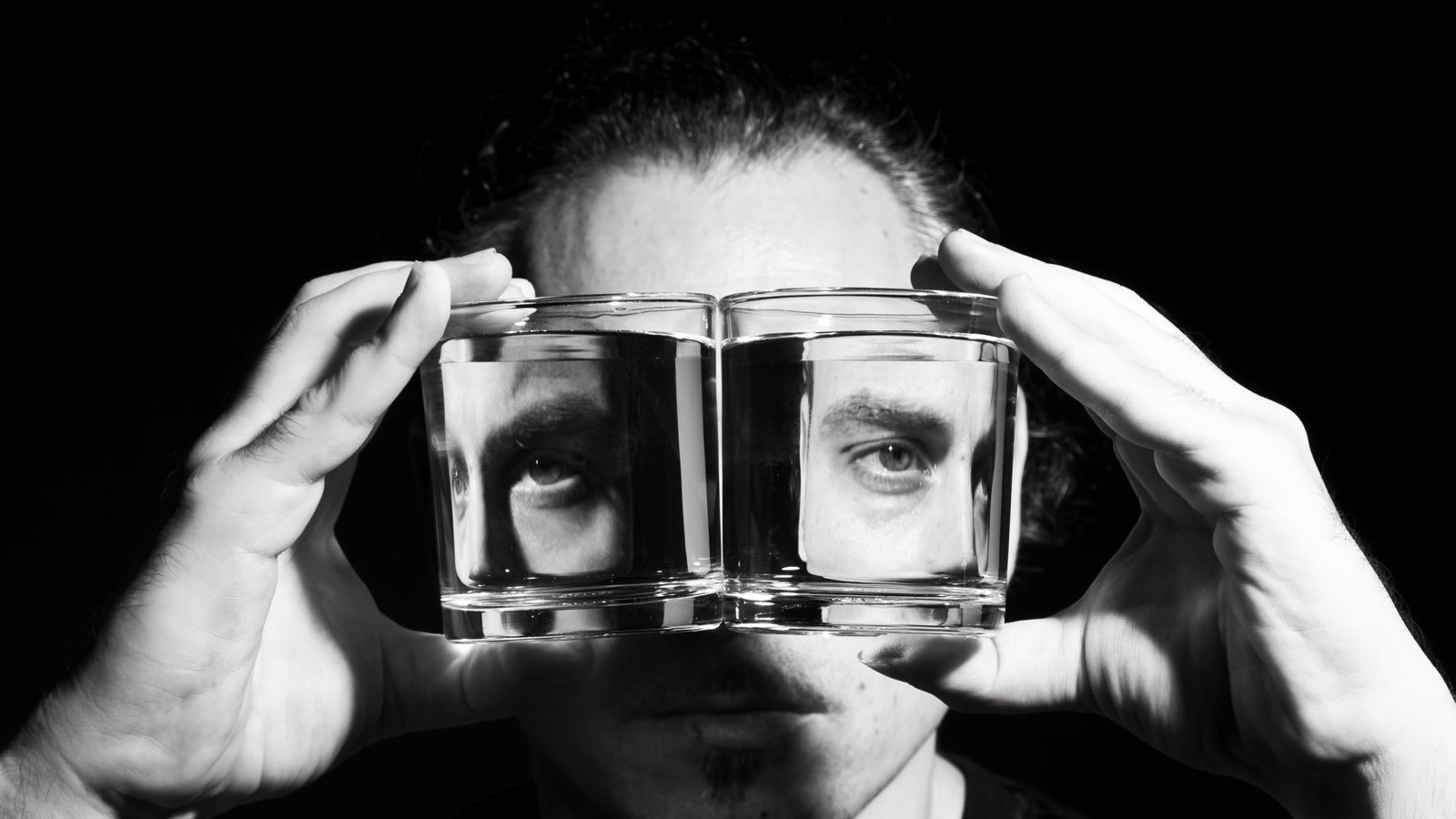 Man shown in facets of a glass square